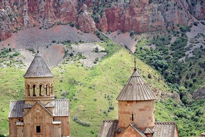 Built structure on landscape with mountain in background