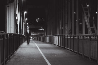 People walking on illuminated street at night