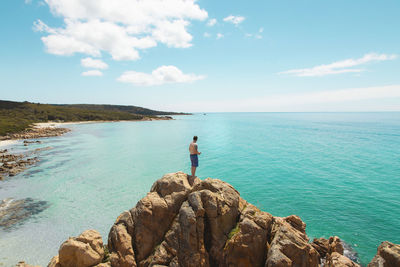 Scenic view of rocks in sea against sky