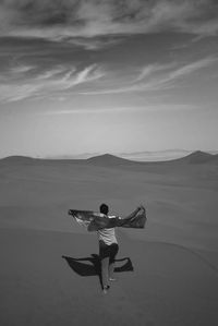 Man on desert against sky