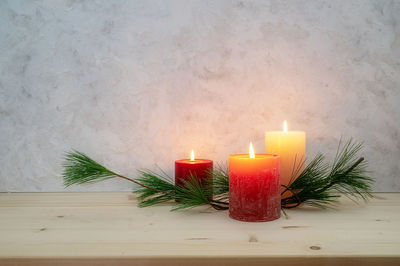 Close-up of illuminated candles on table