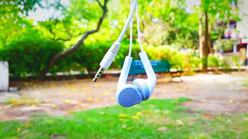 Close-up of swing hanging in park