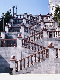 Man standing on staircase against building