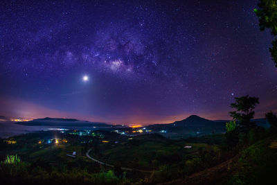 Scenic view of mountains against sky at night