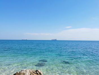 Scenic view of sea against blue sky