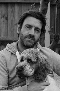 Portrait of man with cockapoo dog