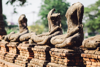 Close-up of old statue against temple