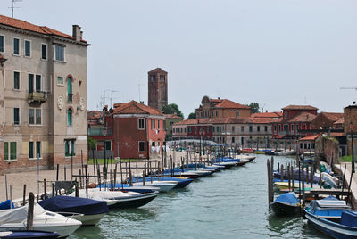 Canal with boats on the island of murano, venezia, veneto, italy.