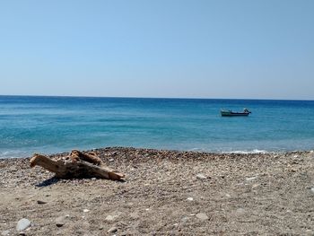 Scenic view of turquoise sea against clear sky