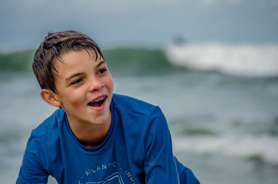 Portrait of smiling boy against sea
