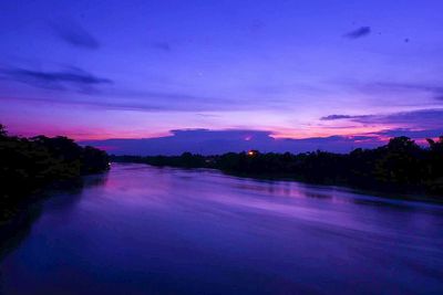 Scenic view of lake against sky at sunset