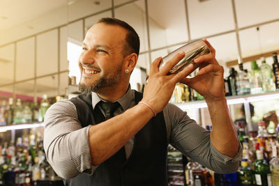 Smiling bartender at bar