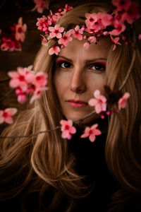 Close-up of young woman with flowers