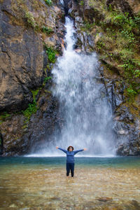 Full length of man standing on rocks