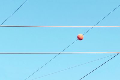 Low angle view of cables against clear blue sky