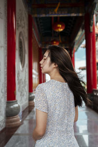 Rear view of woman standing in corridor