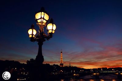 Low angle view of illuminated street light against sky at night