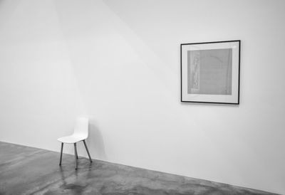 Chairs and tables against wall