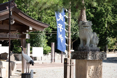 Statue in park against building