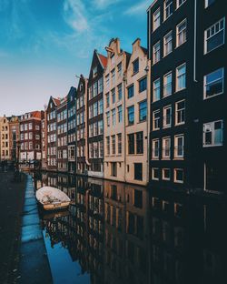 Boat moored on canal by row houses