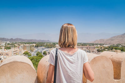 Rear view of woman looking at cityscape