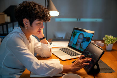 Young woman using laptop at home