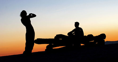 Silhouette of statue against sky at sunset