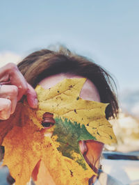 Close-up of human hand holding leaves