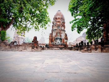 Surface level of old temple against building