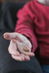 Midsection of woman holding snail