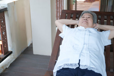 Senior woman relaxing on deck chair