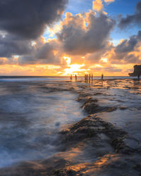 Scenic view of beach against sky during sunset