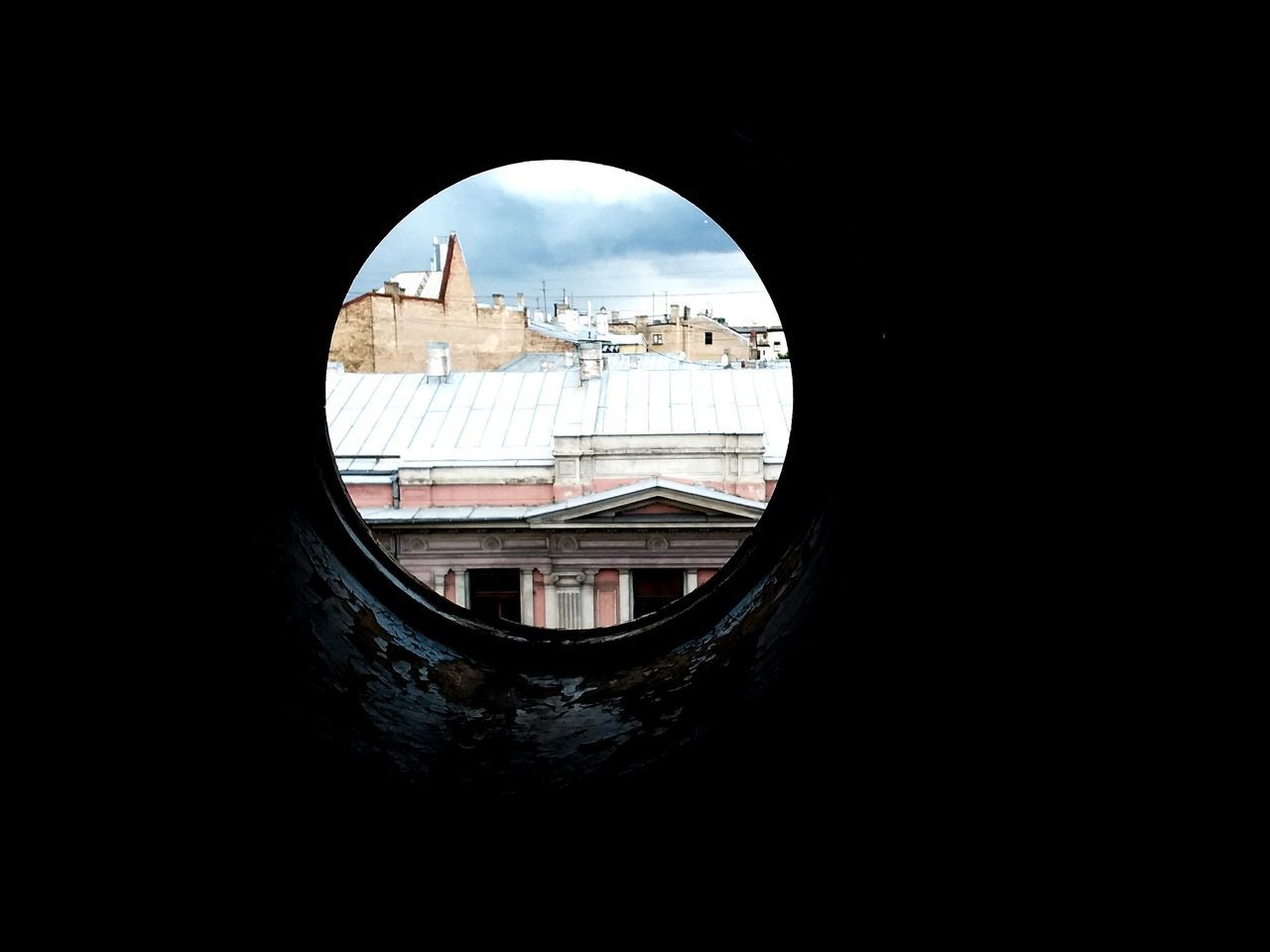 BUILDINGS SEEN THROUGH ARCH OF A CHURCH