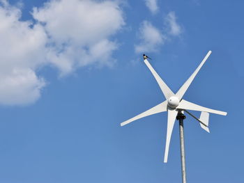 Low angle view of wind turbine against sky