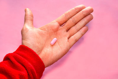 Cropped image of person gesturing against wall