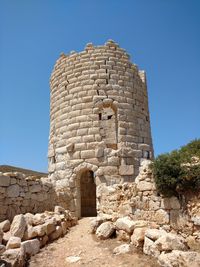 Low angle view of historical building against clear blue sky