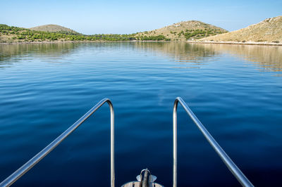 Scenic view of swimming pool by lake against sky