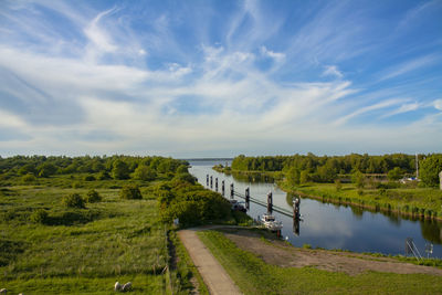 Scenic view of landscape against clouded sky