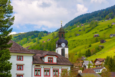 Houses on mountain against sky