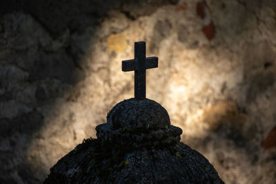 Close-up of cross in cemetery against sky