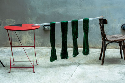 High angle view of empty chairs and table against wall