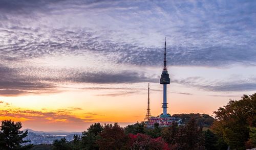 Communications tower against sky during sunset