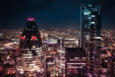 Aerial view of city lit up at night