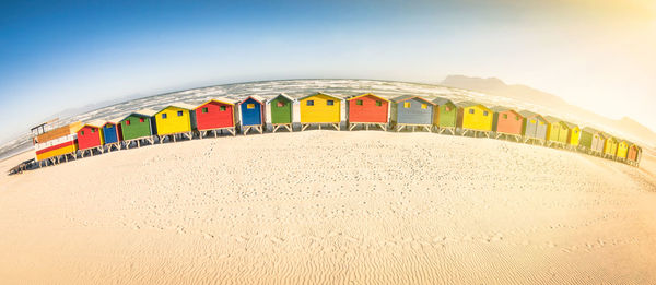 Multi colored umbrellas on beach against clear sky