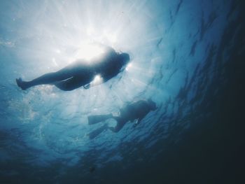 Low angle view of woman swimming in sea