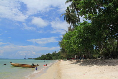 People on beach against sky