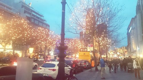 Illuminated street light against sky