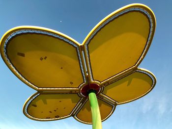 Low angle view of yellow decoration against sky
