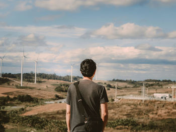 Rear view of man standing on field