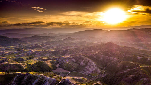 Aerial view of landscape against sky during sunset